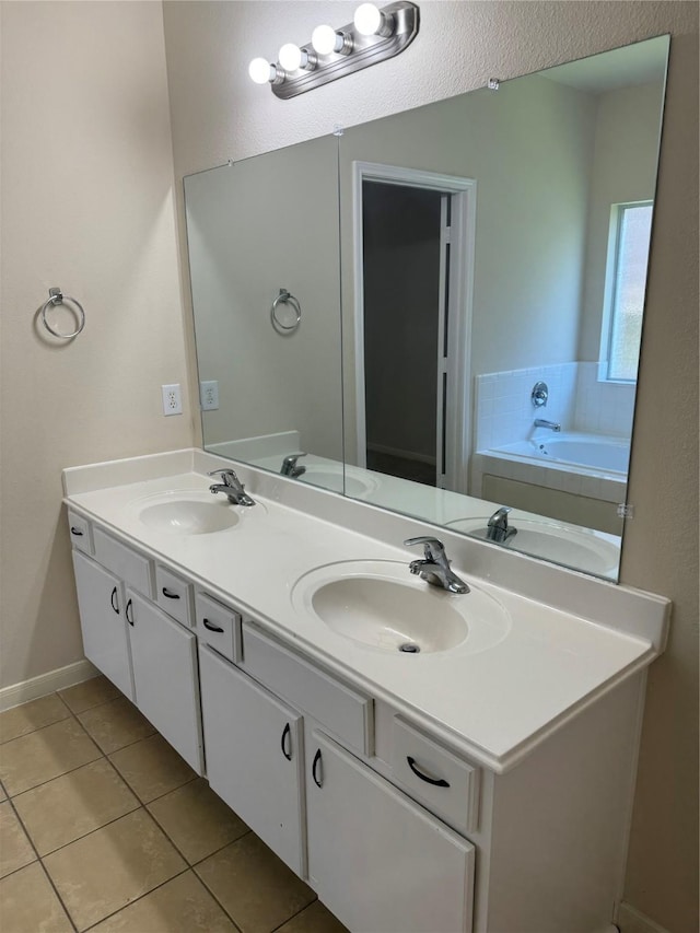 bathroom featuring tile patterned flooring, a bathtub, and vanity