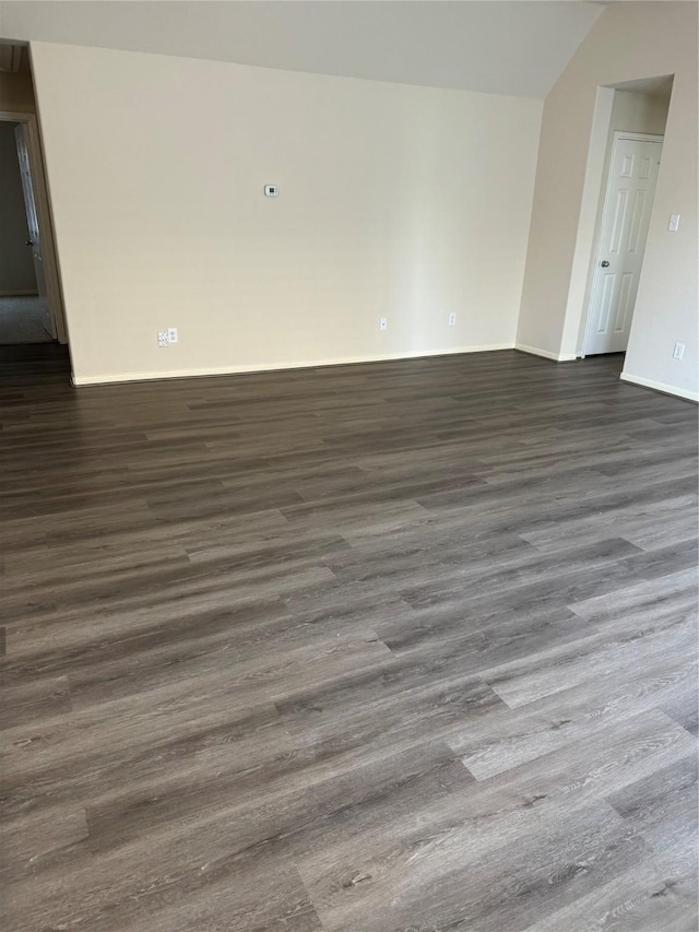 unfurnished room featuring dark wood-type flooring