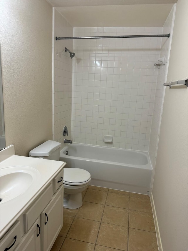 full bathroom featuring toilet, tiled shower / bath, tile patterned flooring, and vanity