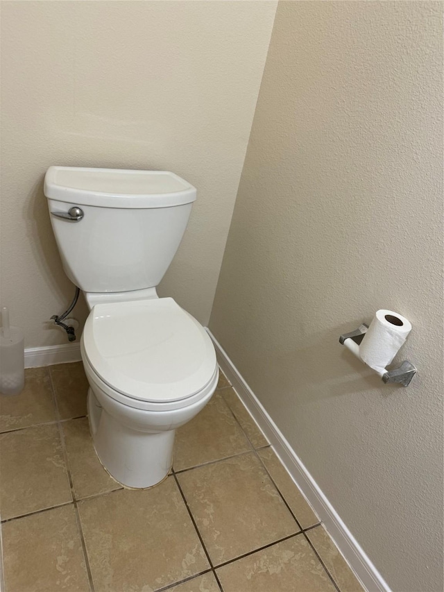 bathroom with toilet and tile patterned floors