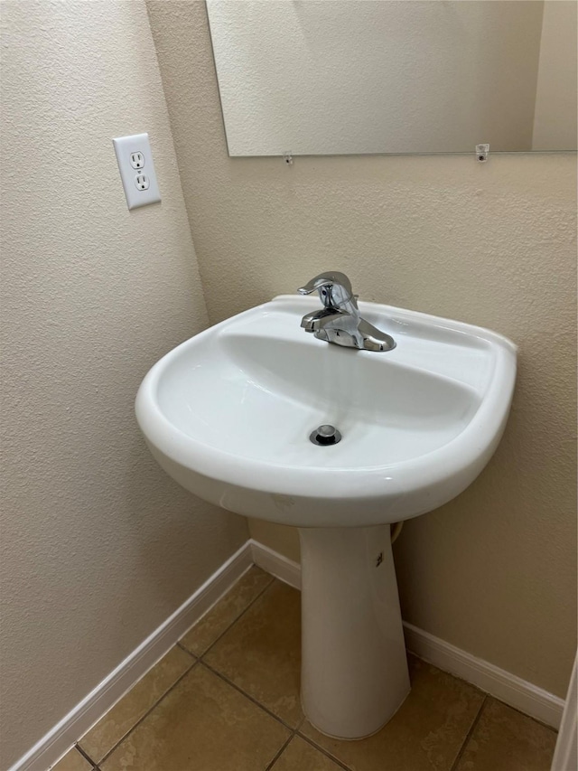 bathroom with tile patterned flooring and sink