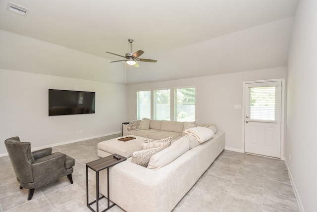 tiled living room with ceiling fan, a healthy amount of sunlight, and vaulted ceiling