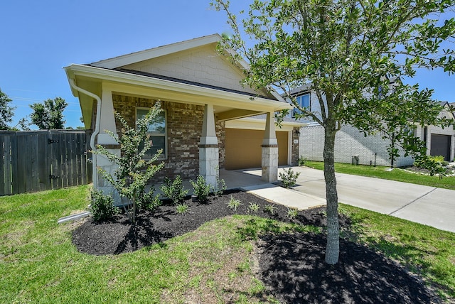 view of front of property featuring a garage and a front lawn