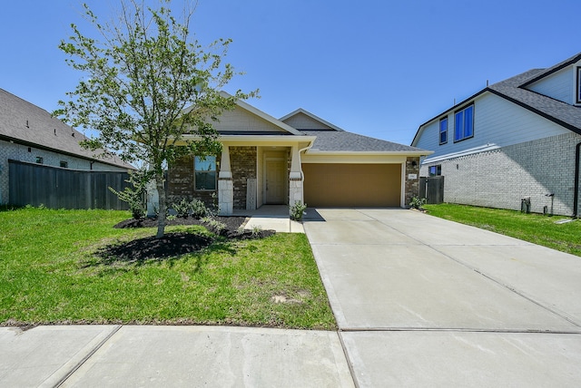 view of front of home featuring a front yard and a garage