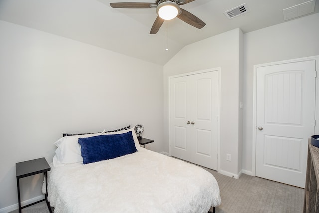 bedroom with ceiling fan, vaulted ceiling, and light colored carpet