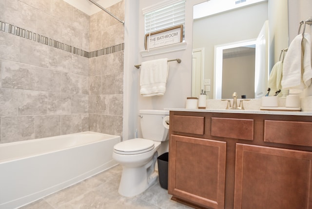 full bathroom featuring tile flooring, tiled shower / bath combo, vanity, and toilet