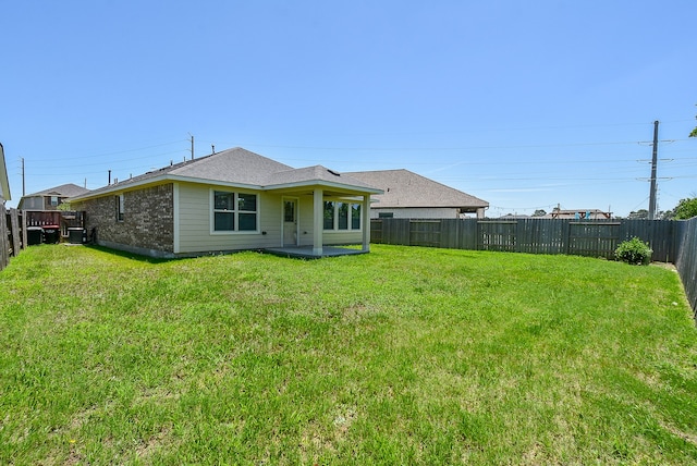 back of house with a yard