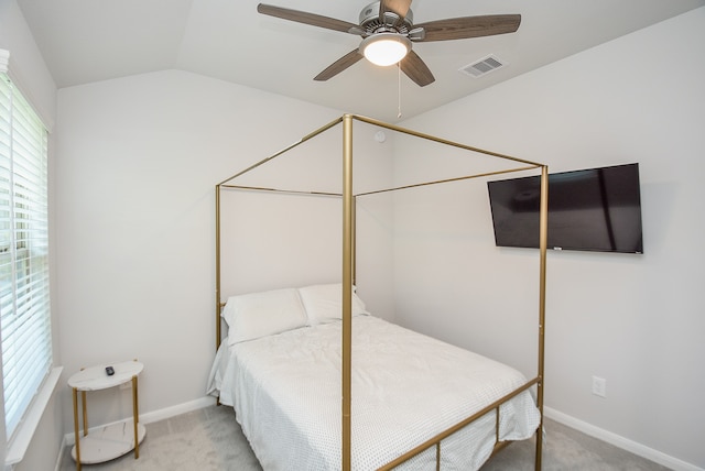 carpeted bedroom featuring lofted ceiling and ceiling fan