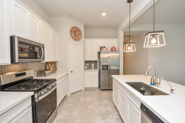 kitchen with appliances with stainless steel finishes, pendant lighting, sink, tasteful backsplash, and light tile floors