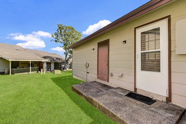 entrance to property with a lawn