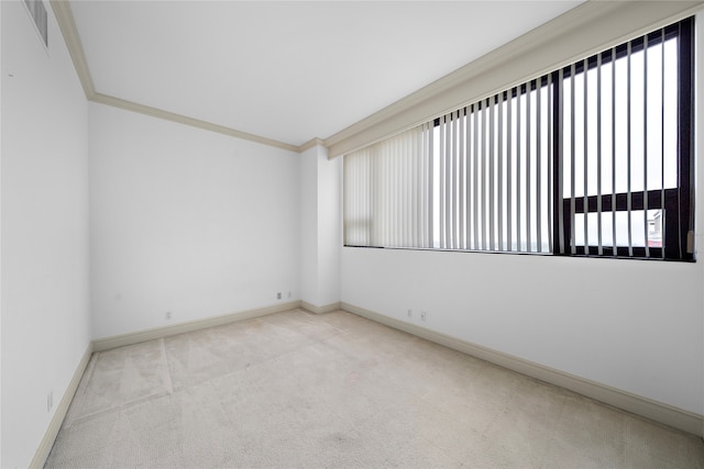 empty room with light colored carpet and ornamental molding