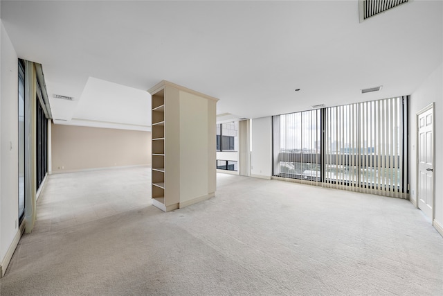 unfurnished living room featuring light carpet