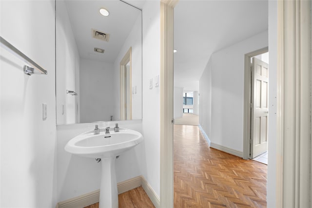 bathroom featuring parquet flooring