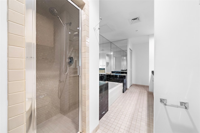 bathroom with tile patterned flooring and independent shower and bath