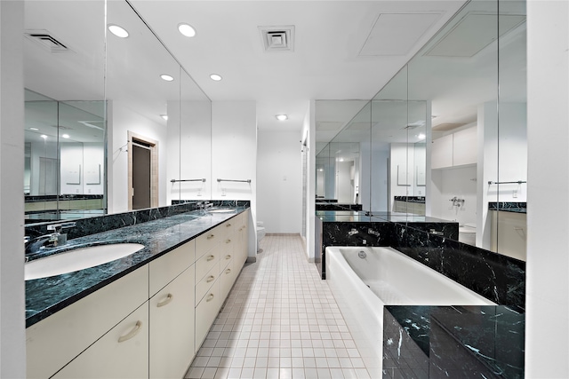 bathroom with tile patterned floors, vanity, and toilet