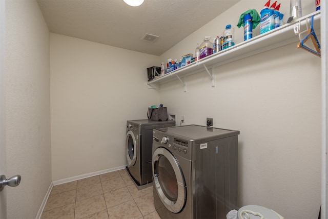 clothes washing area with electric dryer hookup, separate washer and dryer, light tile flooring, and hookup for a washing machine