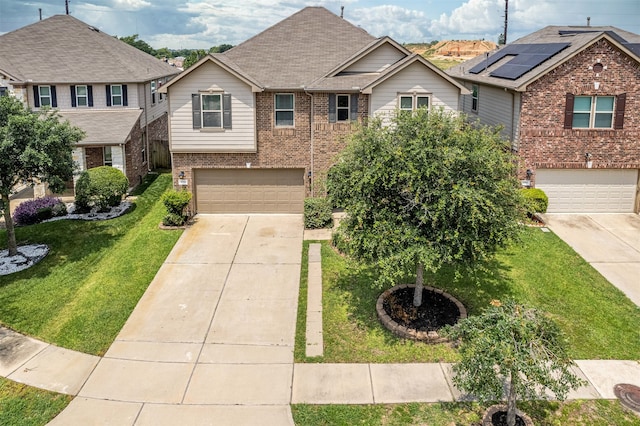 view of front of house featuring a front yard, a garage, and solar panels