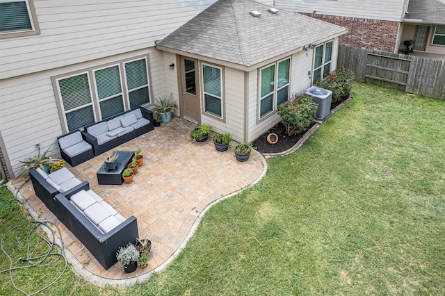 rear view of house featuring a patio, central AC, outdoor lounge area, and a yard