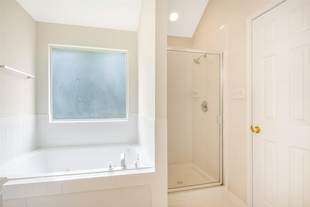 bathroom with lofted ceiling and independent shower and bath