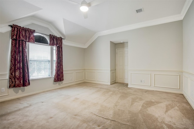 unfurnished room with light carpet, crown molding, and vaulted ceiling