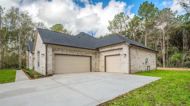 view of home's exterior with a garage and a lawn