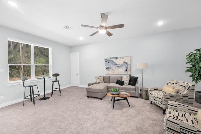 living room featuring light colored carpet and ceiling fan