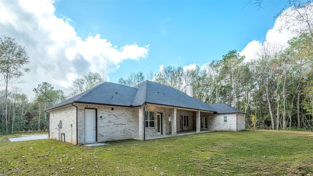 back of house featuring a patio and a lawn