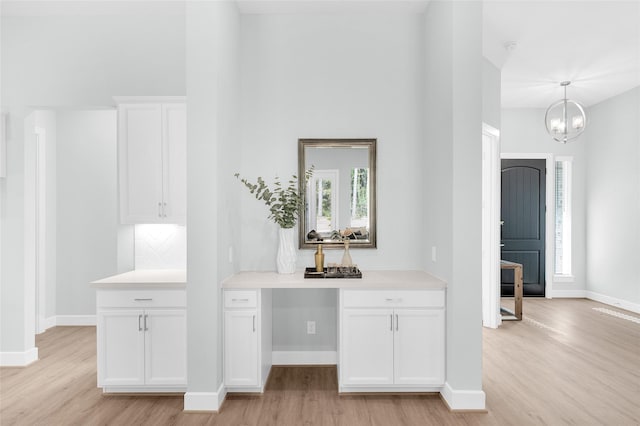 interior space with light hardwood / wood-style floors and an inviting chandelier