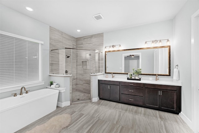 bathroom featuring separate shower and tub, ceiling fan, and vanity