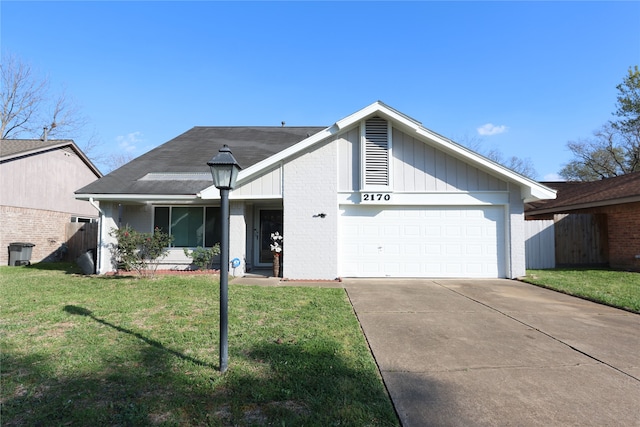 view of front facade with a front yard and a garage