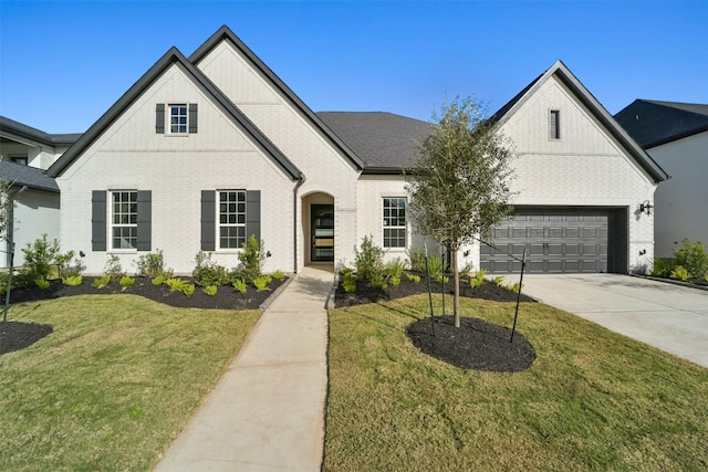 view of front of house with a front lawn and a garage