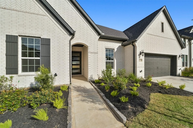 doorway to property with a garage