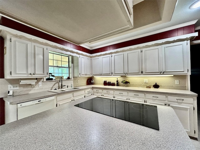 kitchen featuring light countertops, white dishwasher, a sink, and white cabinetry