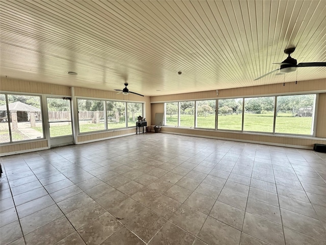 unfurnished sunroom with ceiling fan