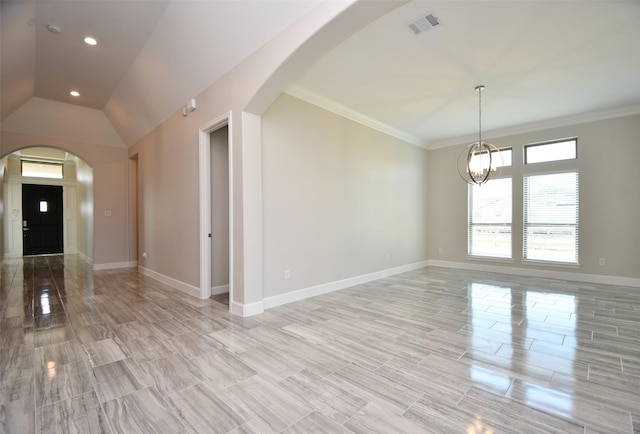 interior space featuring vaulted ceiling, light wood-type flooring, ornamental molding, and an inviting chandelier