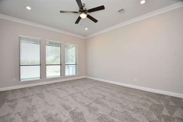 unfurnished room featuring ceiling fan, light colored carpet, and ornamental molding