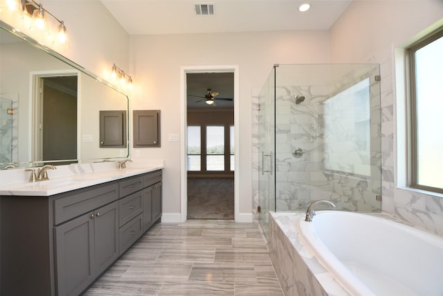 bathroom with vanity, separate shower and tub, a wealth of natural light, and ceiling fan