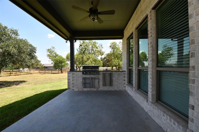 view of patio / terrace featuring grilling area, ceiling fan, and exterior kitchen