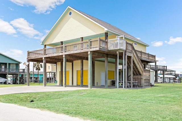 rear view of house with a lawn and a wooden deck