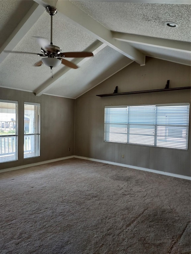 empty room featuring vaulted ceiling with beams, ceiling fan, a textured ceiling, and carpet