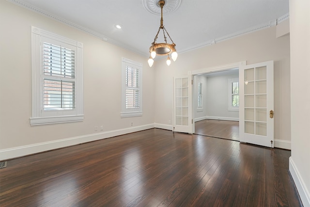 unfurnished room with french doors, ornamental molding, dark wood-type flooring, and a wealth of natural light