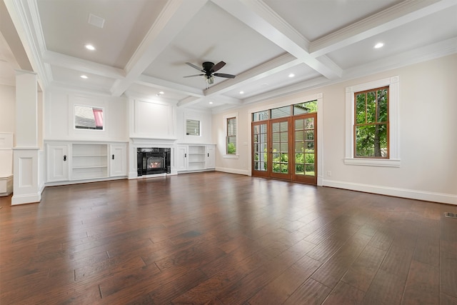 unfurnished living room with coffered ceiling, a healthy amount of sunlight, beam ceiling, and ceiling fan