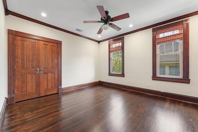 unfurnished bedroom with ornamental molding, dark hardwood / wood-style floors, and ceiling fan