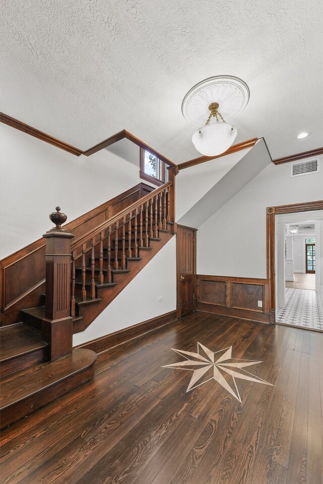 unfurnished living room with hardwood / wood-style floors and a textured ceiling