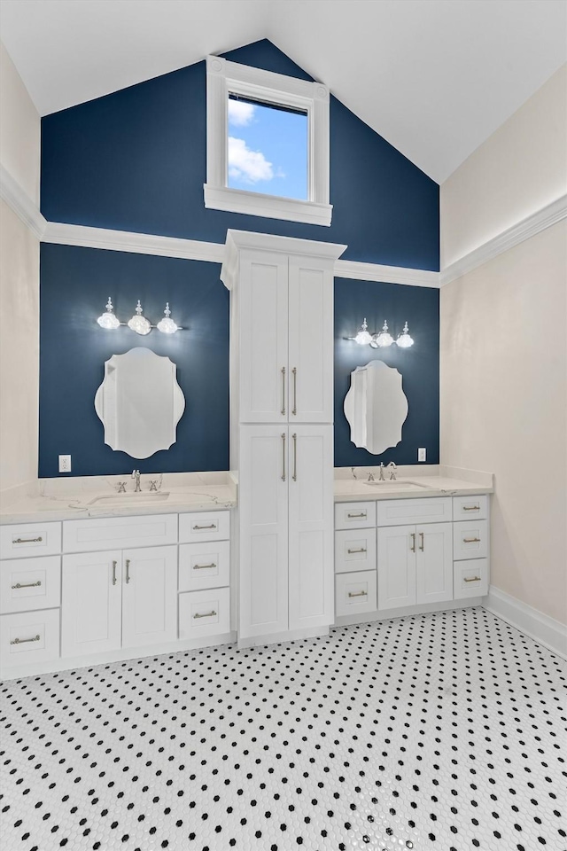 bathroom with vanity, vaulted ceiling, and tile patterned floors