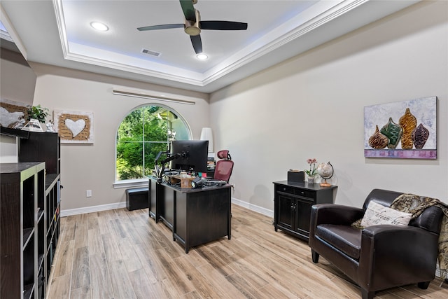 office area featuring ceiling fan, ornamental molding, a tray ceiling, and light hardwood / wood-style floors