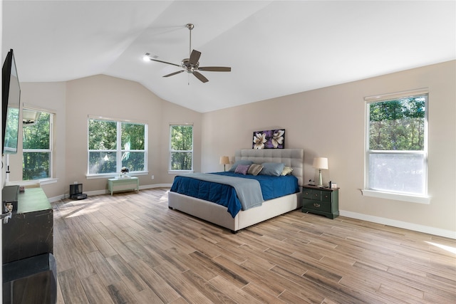 bedroom with multiple windows, wood-type flooring, and ceiling fan