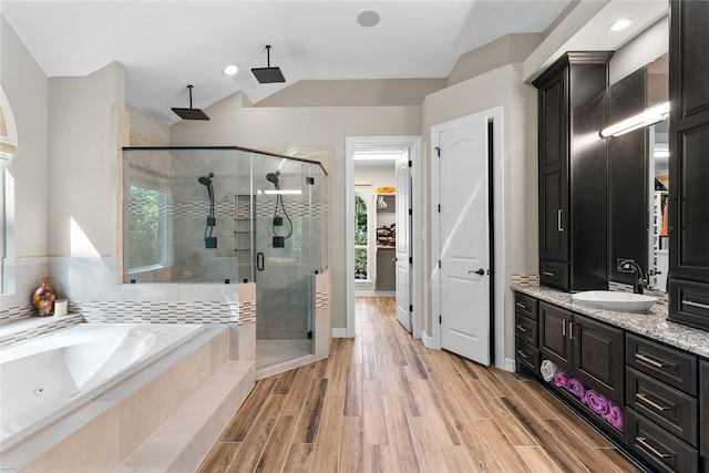 bathroom with vanity and shower with separate bathtub