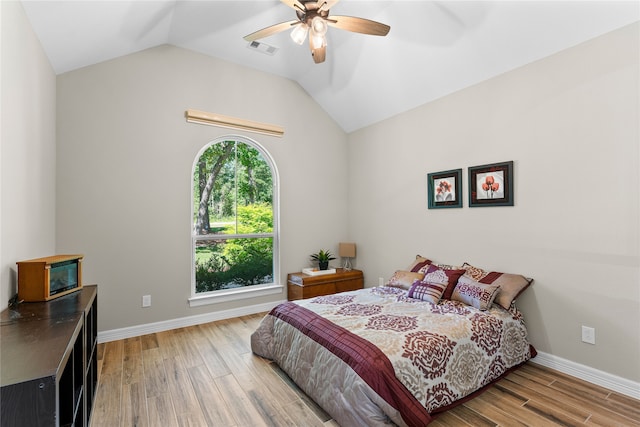 bedroom featuring hardwood / wood-style flooring, ceiling fan, and lofted ceiling