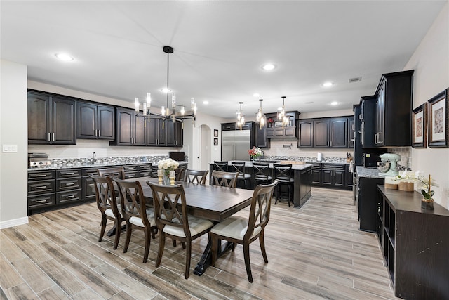 dining area featuring a chandelier and light hardwood / wood-style flooring